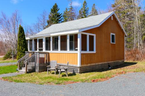 a small house with a bench in front of it at Tracadie Cottages in York