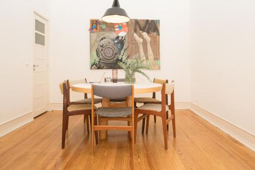 stół jadalny z krzesłami i obraz na ścianie w obiekcie Flattered to be in Lisboa w Lizbonie