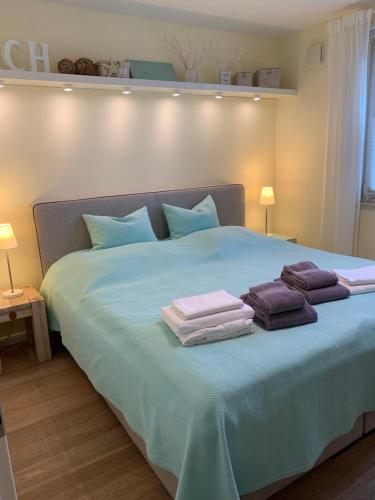 a bedroom with a bed with towels on it at Beach Home in Böhl