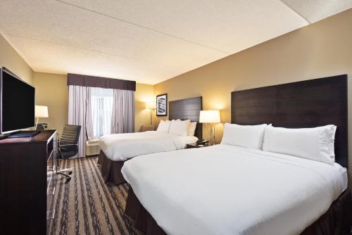 a hotel room with two beds and a flat screen tv at Holiday Inn Harrisburg East by IHG in Middletown