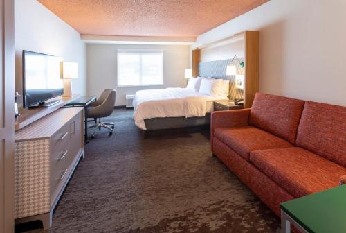 マーケットにあるHoliday Inn Marquette, an IHG Hotelのベッドとソファ付きのホテルルーム