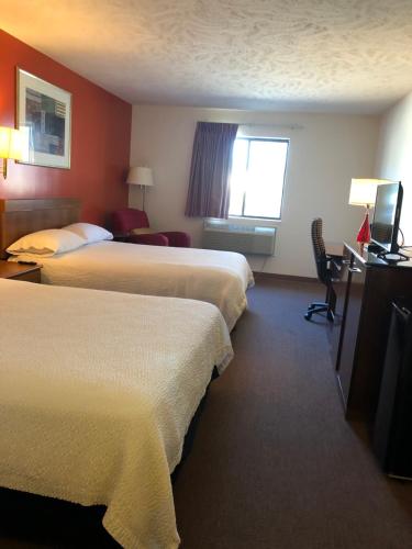 Ένα ή περισσότερα κρεβάτια σε δωμάτιο στο Coronado Motel & RV Park