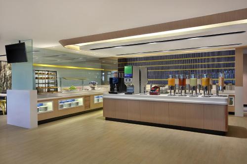 a restaurant with a bar with drinks on it at Holiday Inn Express Kuala Lumpur City Centre by IHG in Kuala Lumpur