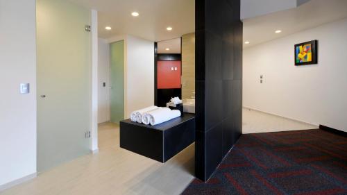 a room with a bed and a mirror at Holiday Inn Mexico Dali Airport by IHG in Mexico City