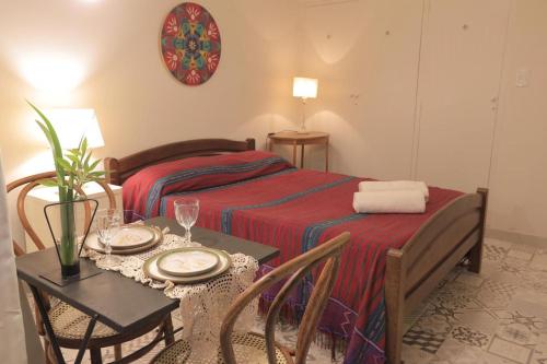 a hotel room with a bed and a table with a tableablish at Loft para 2 personas in San Salvador de Jujuy