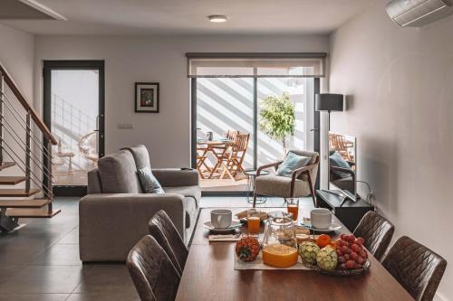 a living room with a table with fruit on it at 9 Furnas Villa in Furnas