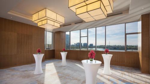 a lobby with white vases with flowers in them at Holiday Inn Nanjing Qinhuai South by IHG in Jiangning