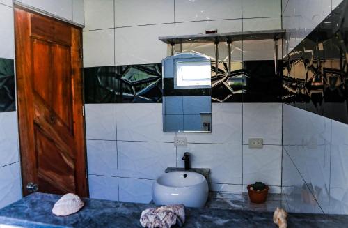 a bathroom with a sink and a mirror at Tablas Seaview Homestay in Ferrol