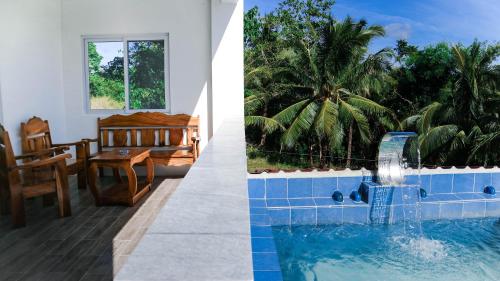 a house with a swimming pool and a dining room at Tablas Seaview Homestay in Ferrol