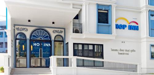 a white building with a hop inn sign on it at HOP INN Phuket Old Town in Phuket Town