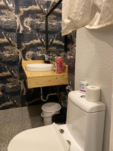 a bathroom with a toilet and a sink at Monallan Boracay Hotel in Boracay