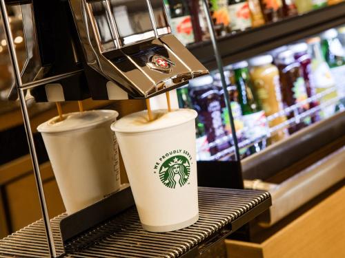 two coffee cups sitting on a counter in a store at Holiday Inn Antalya - Lara by IHG in Antalya
