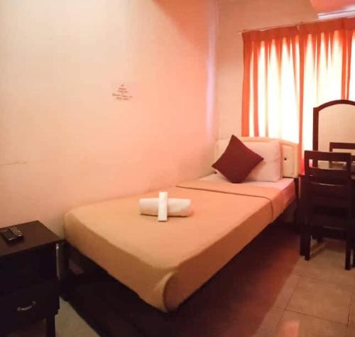 Postel nebo postele na pokoji v ubytování Amax Inn Cebu