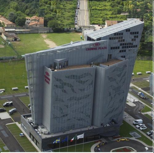 a large white building with writing on the side of it at Crowne Plaza Verona Fiera by IHG in Verona