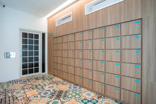 a room with a wooden wall with a tile floor at Bobopod Kota Lama, Semarang in Semarang
