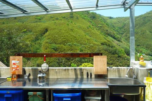 a kitchen counter with a view of a mountain at Shuitianfarm in Jianshi