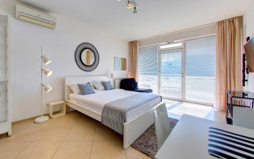 a bedroom with a bed and a large window at Villa Katarina 2nd Floor Apartments in Dubrovnik