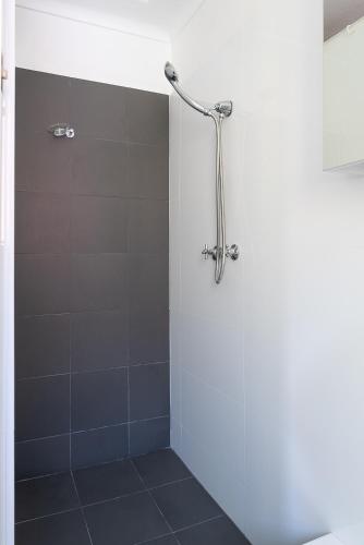 a bathroom with a shower with a glass door at Lotus Stay Manly - Apartment 31F in Sydney