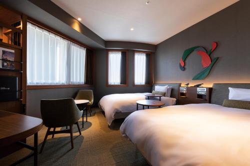 a hotel room with two beds and a tv at Hotel JAL City Haneda Tokyo in Tokyo