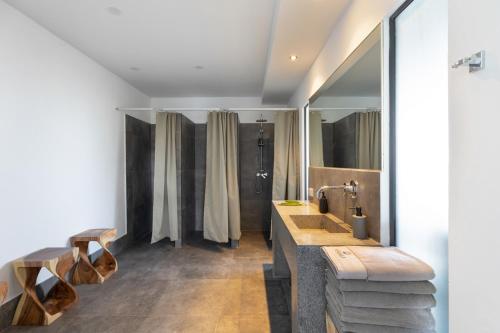 a bathroom with two sinks and a shower at Kapuhala Koh Samui- Vegan Boutique Hotel in Chaweng Noi Beach