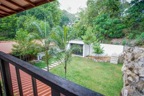 a view from the balcony of a house with a yard at Pineview in Unawatuna
