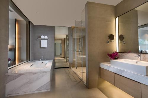 a bathroom with two sinks and a large tub at Holiday Inn Nanjing Harbour, an IHG Hotel in Nanjing