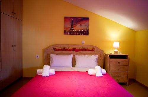 a bedroom with a large bed with a red blanket at Aegean View Seaside Apartment in Kavala