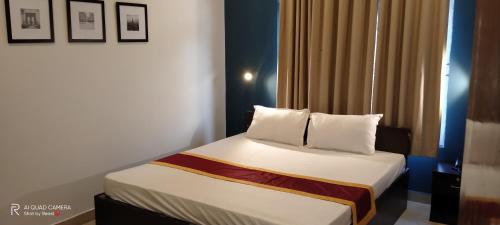 A bed or beds in a room at Swastik Inn