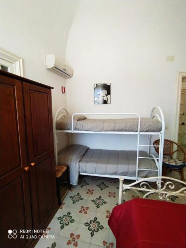 a room with a bunk bed in a room at Agli Antichi Quartieri Apartments & Room in Alcamo