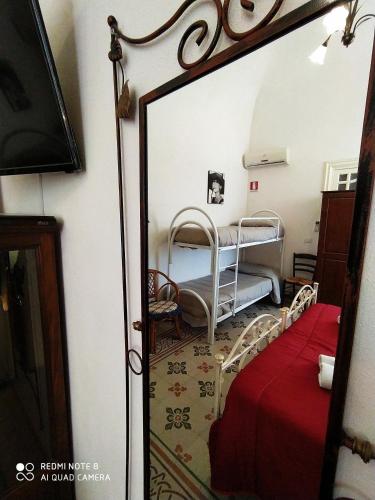 a mirror reflection of a bedroom with a bunk bed at Agli Antichi Quartieri Apartments & Room in Alcamo