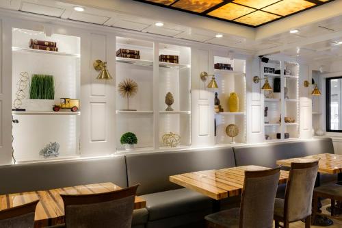 a dining room with tables and shelves of vases at Holiday Inn - Bloomington W MSP Airport Area by IHG in Bloomington