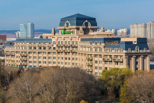 a large building with a tower on top of it at Holiday Inn Mudanjiang by IHG in Mudanjiang