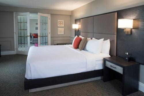 a large white bed in a hotel room at Crowne Plaza Fredericton Lord Beaverbrook by IHG in Fredericton