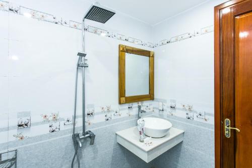 a bathroom with a sink and a mirror at Legend Connect Homestay in Hoi An