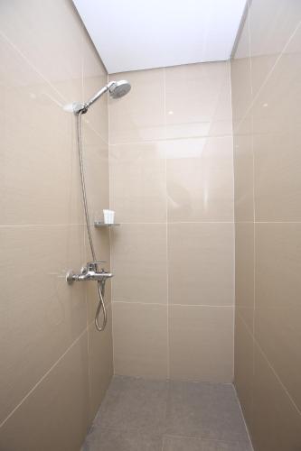 a bathroom with a shower with a glass door at Belmont Hotel Boracay near Newcoast Beach in Boracay