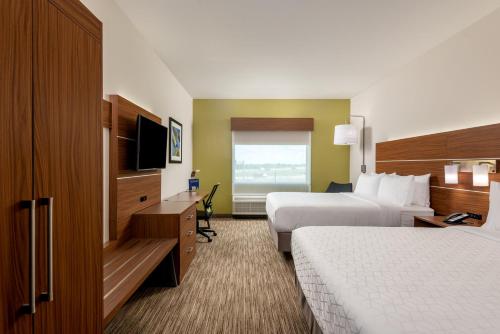 a hotel room with two beds and a television at Holiday Inn Express & Suites - Punta Gorda by IHG in Punta Gorda