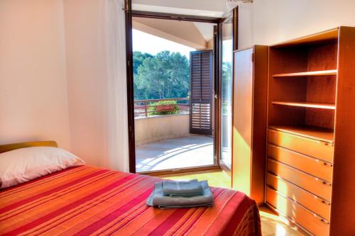 a bedroom with a bed and a large glass window at Apartment Josip 2011 in Fažana