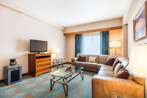 a living room with a couch and a flat screen tv at Holiday Inn Convention Center by IHG in Managua