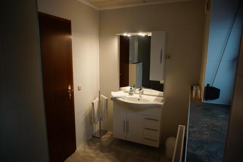 a bathroom with a sink and a mirror at Ferienwohnung Liebeskind in Hopfgarten