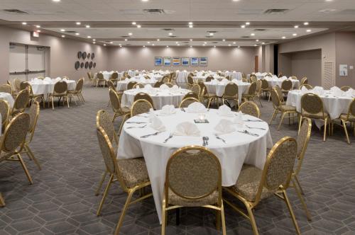 a conference room with white tables and chairs at Holiday Inn Marquette by IHG in Marquette