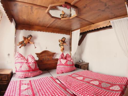 a bedroom with a bed with red and white pillows at Landgasthof & Landhaus Hofmeister in Diemelsee