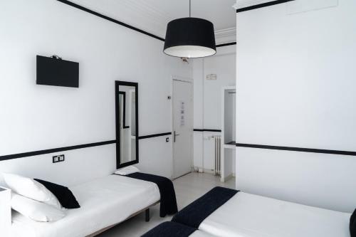 a bedroom with a bed and a desk at Gran Via 63 Rooms in Madrid