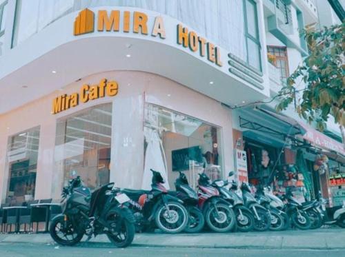a group of motorcycles parked in front of a store at Mira Hotel Quy Nhơn in Quy Nhon