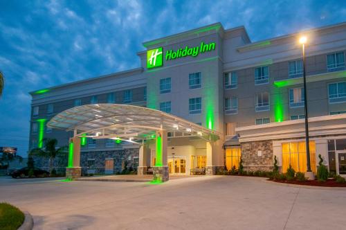 a hotel with a sign on the front of it at Holiday Inn - New Orleans Airport North by IHG in Kenner
