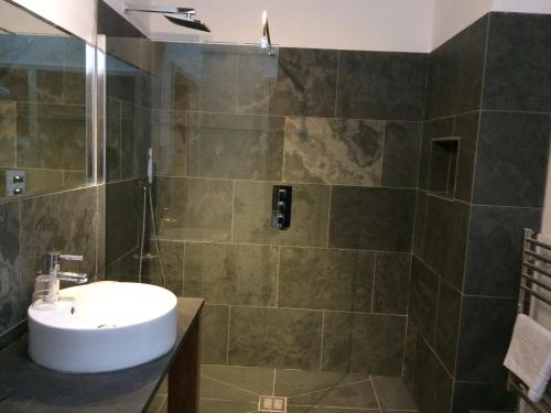 a bathroom with a sink and a shower at Three Chimneys Farm Accommodation in Goudhurst