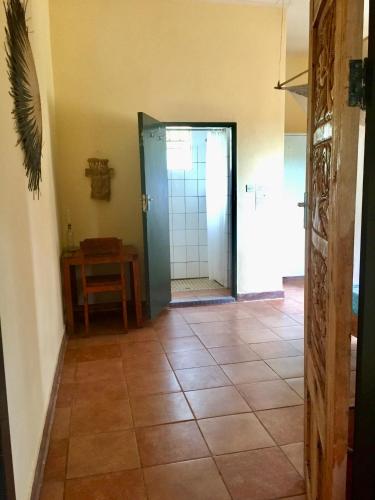 a hallway with a door and a tiled floor at Blend Lodge and Kitchen in Zomba