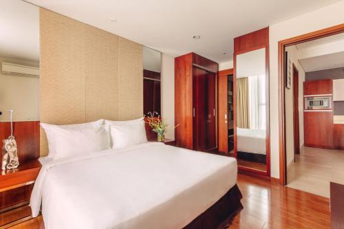 a bedroom with a large white bed in a room at SILA Urban Living in Ho Chi Minh City
