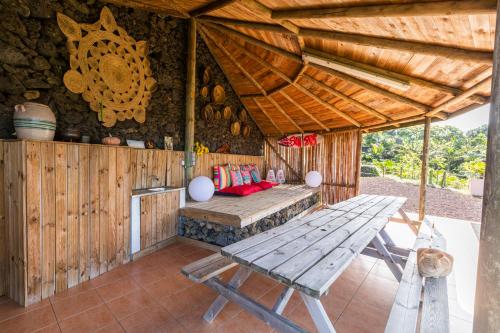a room with a wooden table and a wooden ceiling at Atlantico Apartments in Ribeira Grande