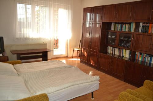 a bedroom with a bed and a book shelf at Granny's in Tvrdošín
