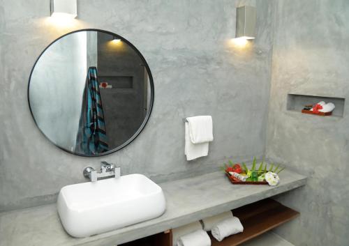 a bathroom with a white sink and a mirror at Eva Lanka Hotel - Beach & Wellness in Tangalle